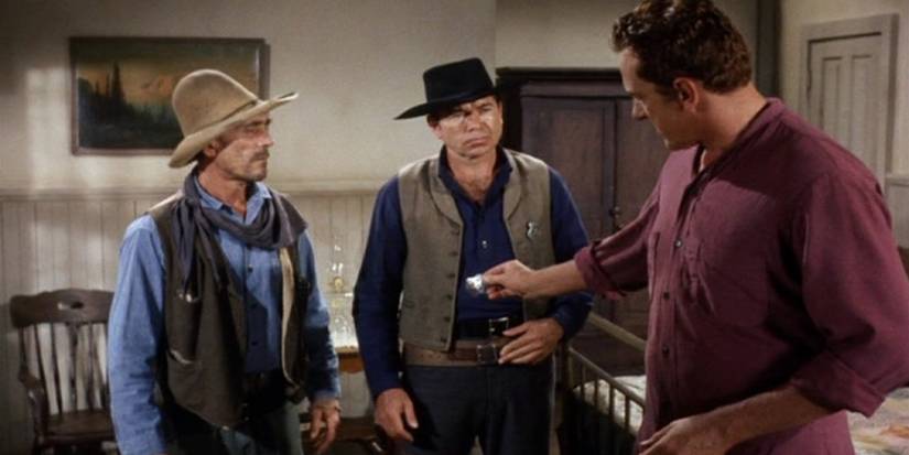 Festus (Ken Curtis) and Marshal Tucker (Claude Akins) watch as Matt Dillon (James Arness) offers his badge in the 'Gunsmoke' episode "Snap Decision"
