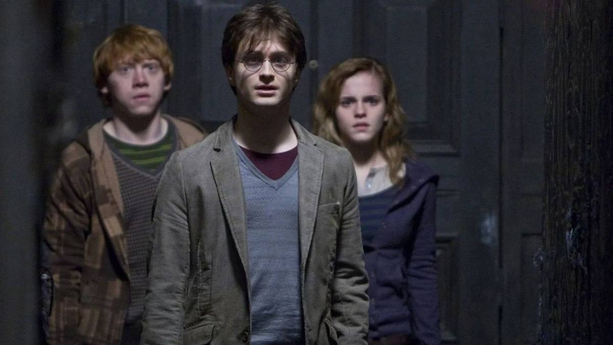 Harry, Ron, and Hermione standing together and looking concerned in Harry Potter and the Deathly Hallows.