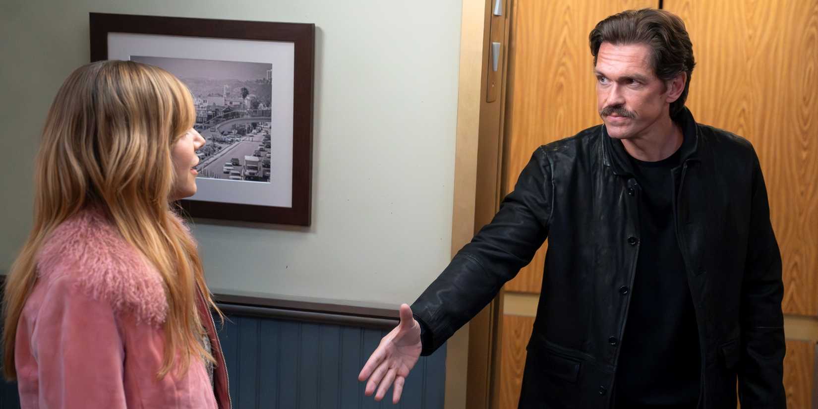 Steve Howey as Captain Wagner reaching out to shake hands with Kaitlin Olson as Morgan in High Potential