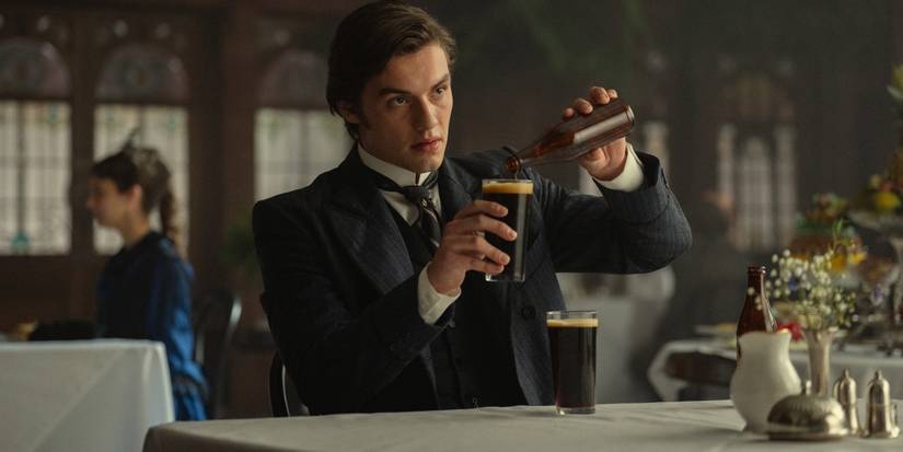 Louis Partridge as Edward Guinness pouring a beer in 'House of Guinness.'