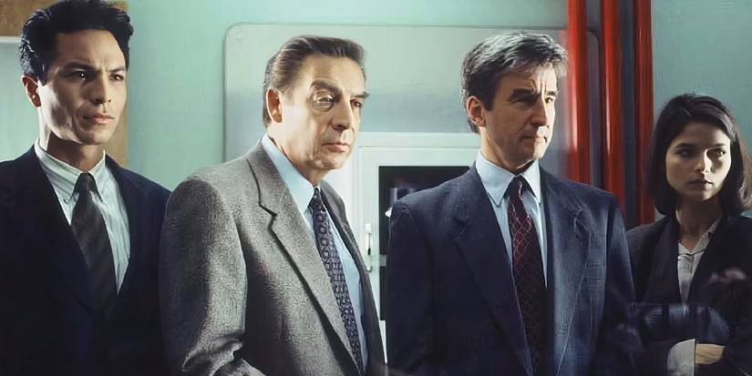 Three men and one woman in suits in Law & Order.