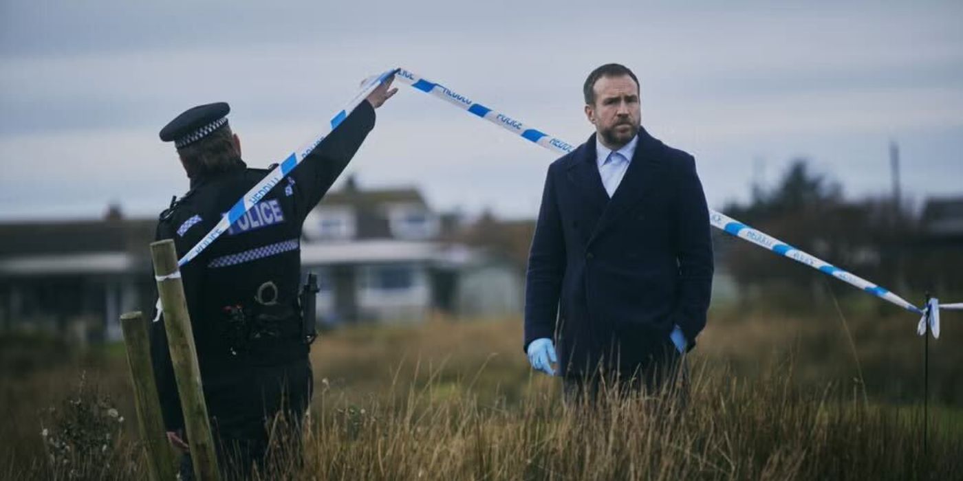 Rafe Spall is with a policeman at a crime scene in Under Salt Marsh.