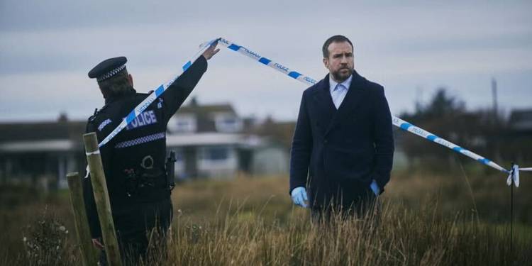 Rafe Spall is with a policeman at a crime scene in Under Salt Marsh.