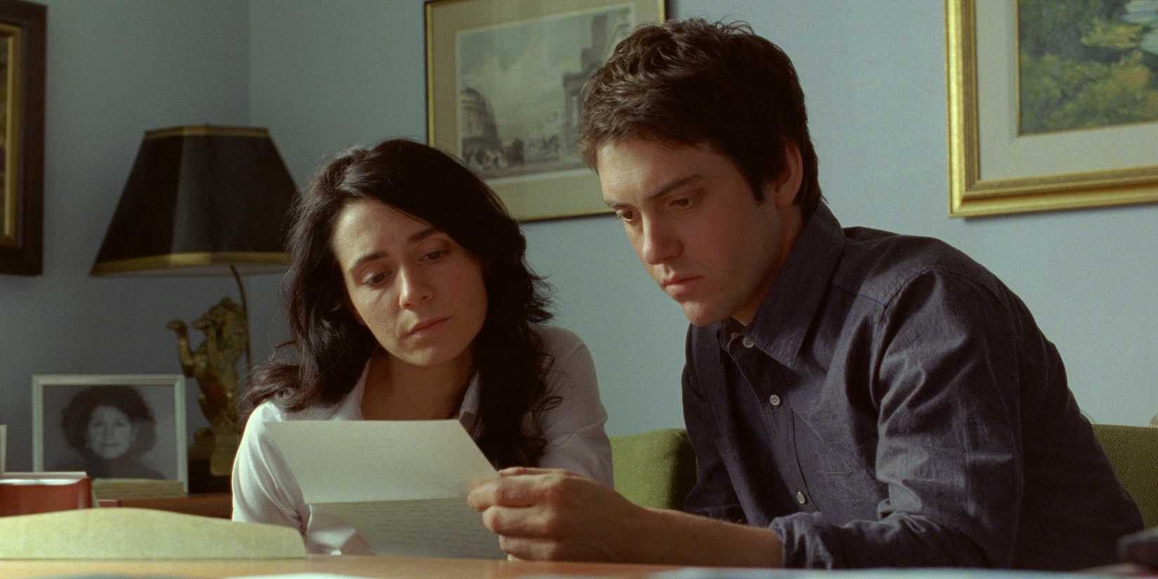 Mélissa Désormeaux-Poulin as Jeanne and Maxim Gaudette as Simon look at a letter in Incendies