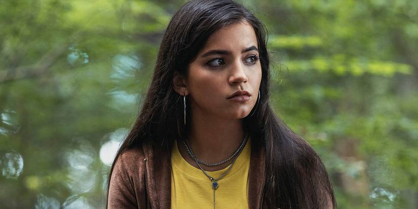 isabela merced looks to the side in the woods in madame web
