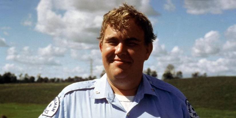John Candy smiling as a state trooper in Sesame Street movie Follow That Bird.