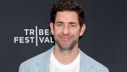 John Krasinski smiling on red carpet