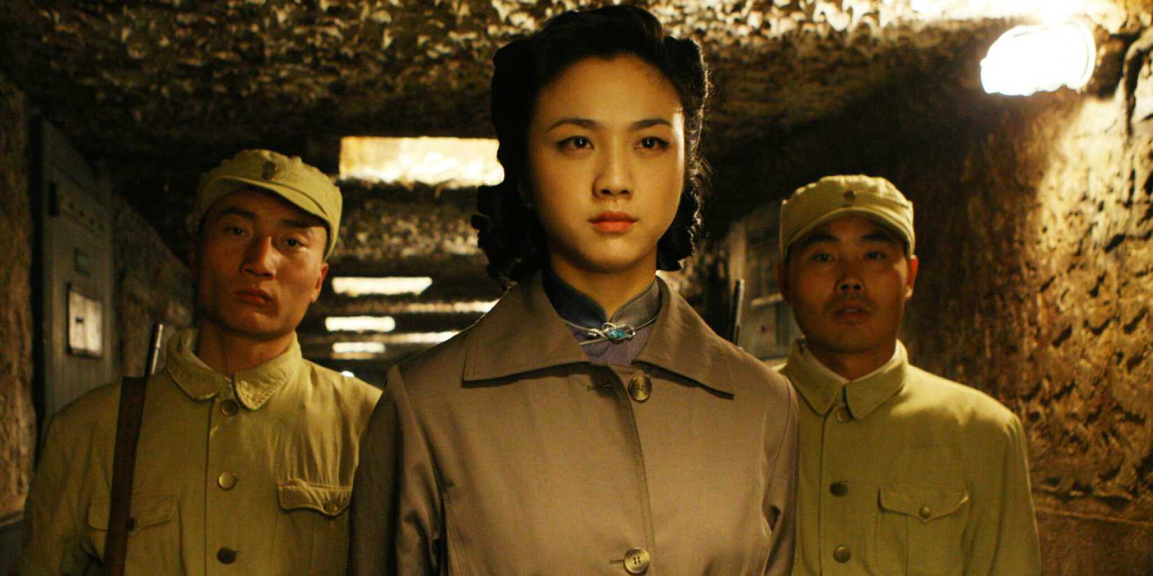 Two male soldiers and one female soldier in an underground bunker in Lust, Caution (2007)
