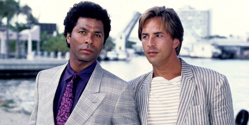 Crockett and Tubbs stand next to one another in Miami Vice.