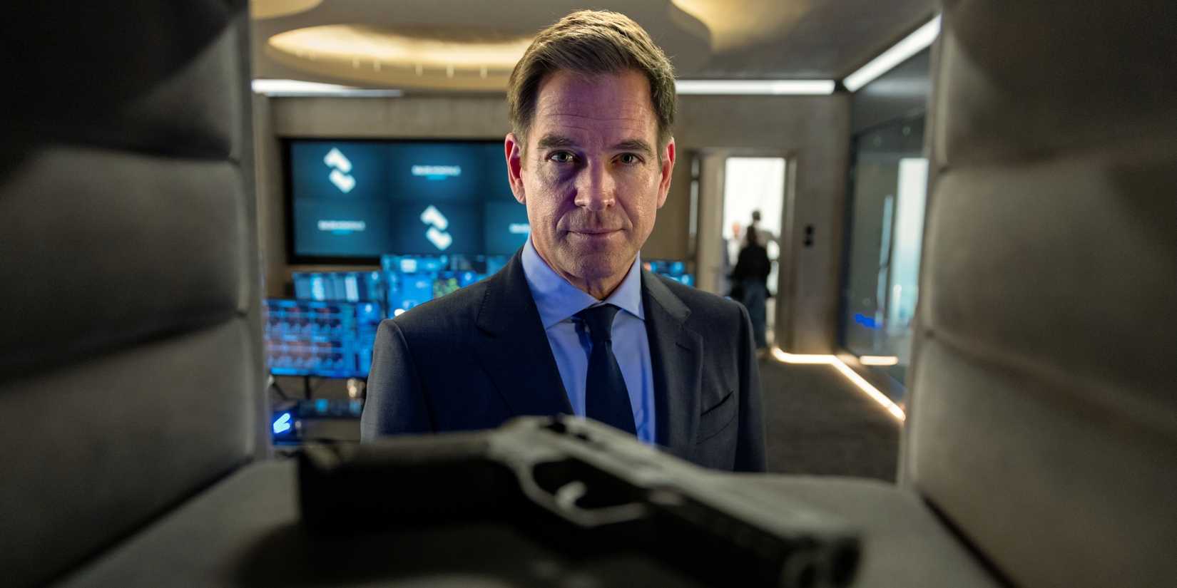 Michael Weatherly as Tony DiNozzo looking at a gun in the foreground in NCIS: Tony & Ziva