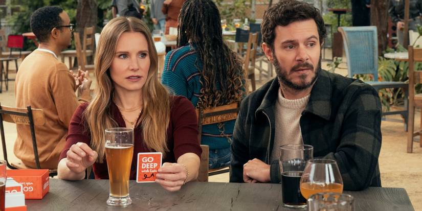 Kristen Bell as Joanne and Adam Brody as Noah at a table in a cafe in Season 2 of 'Nobody Wants This.'
