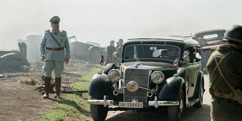 Still from 2025's Nuremberg - a soldier walks near cars