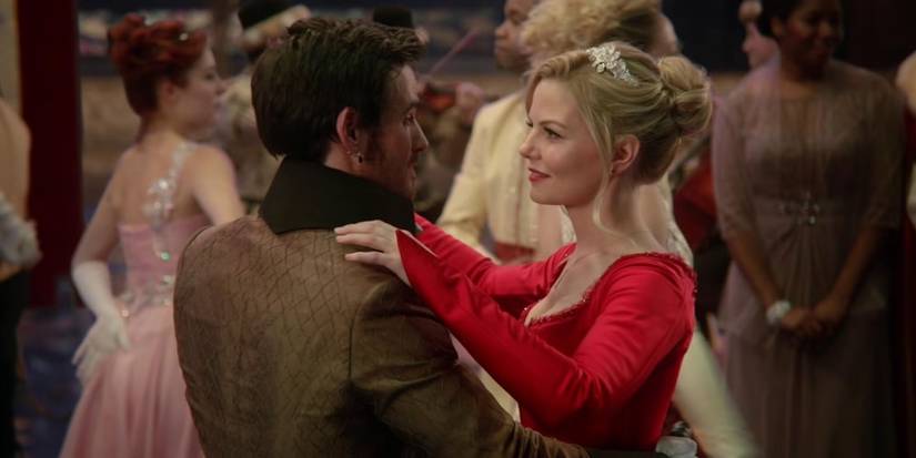 Colin O'Donoghue and Jennifer Morrison in fancy clothes dance together at a ball in Once Upon a Time.