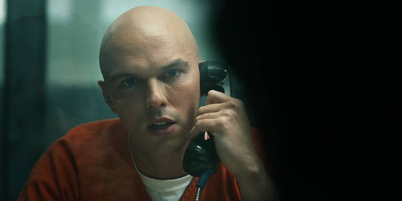 Nicholas Hoult as Lex Luthor talking on a prison phone in Peacemaker Season 2.