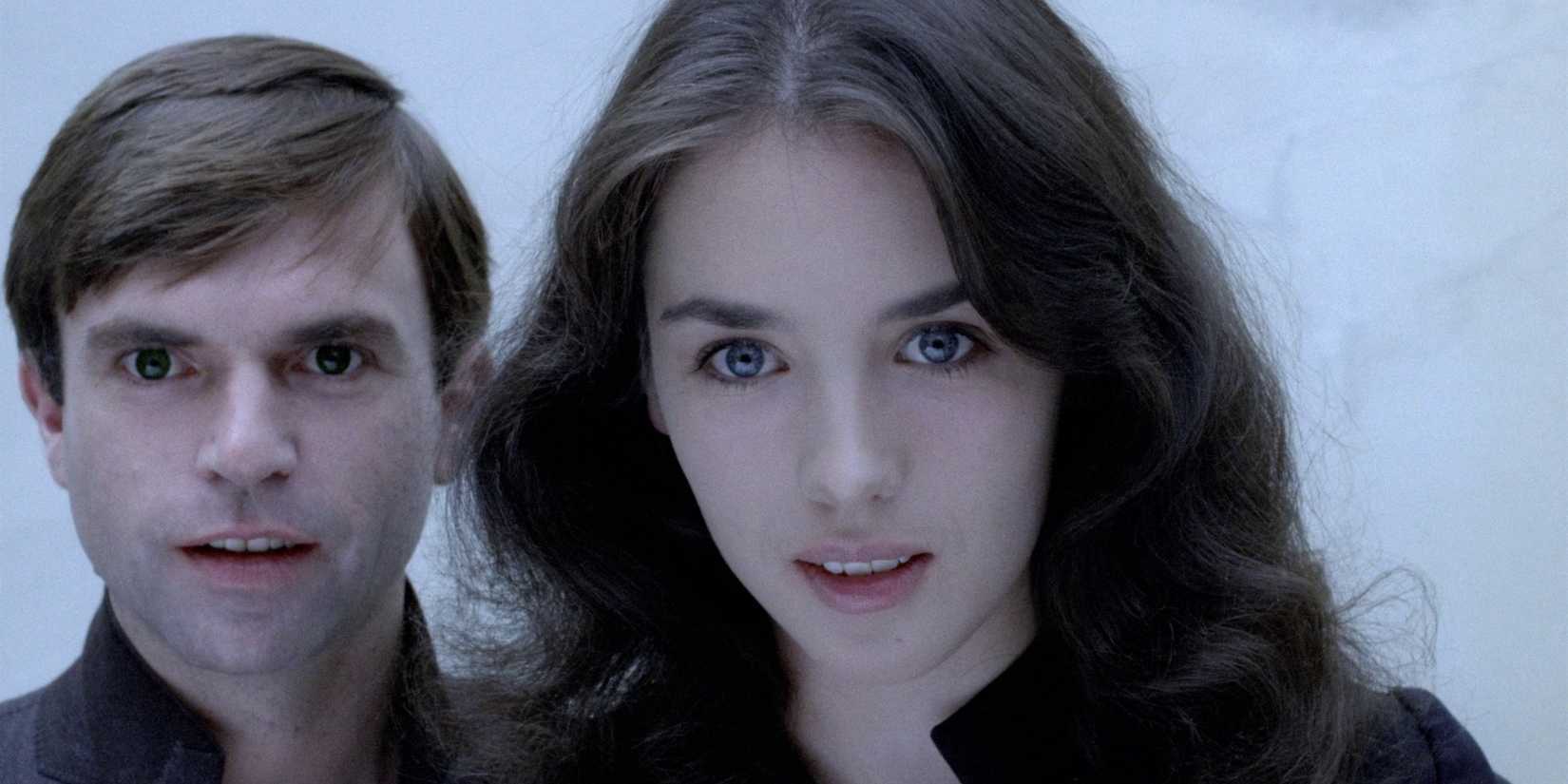 Close-up of Sam Neill as Mark's doppelgänger and Isabelle Adjani as Anna with manic looks on their faces in Possession