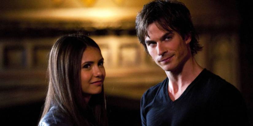 Nina Dobrev and Ian Somerholder as Elena and Damon wearing a black leather jacket and black t shirt smiling in 'The Vampire Diaries'