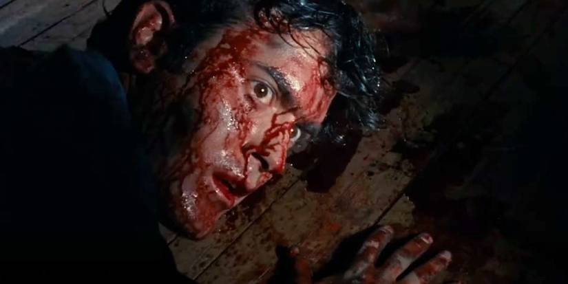 Ash (Bruce Campbell) is covered in blood in The Evil Dead.