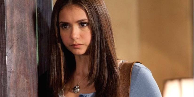Nina Dobrev as Elena wearing a blue shirt and frowning in 'The Vampire Diaries'