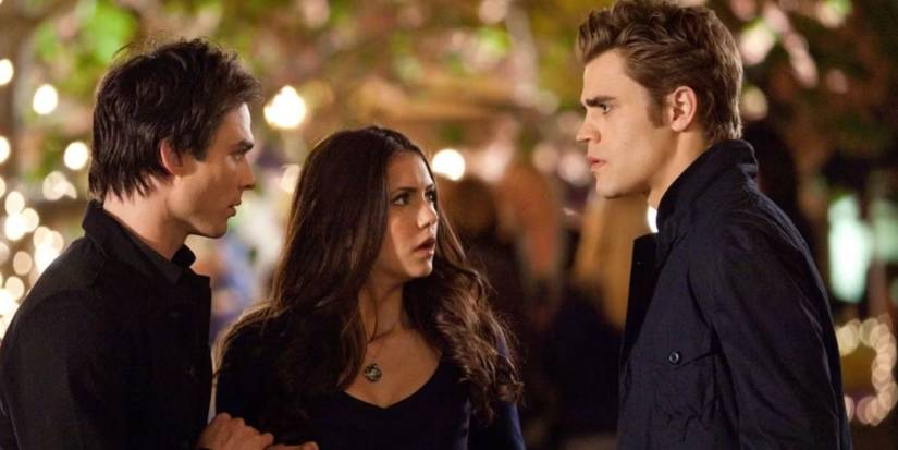 Ian Somerhalder, Nina Dobrev, and Paul Wesley as Damon, Elena, and Stefan standing in the street in black clothes in 'The Vampire Diaries'