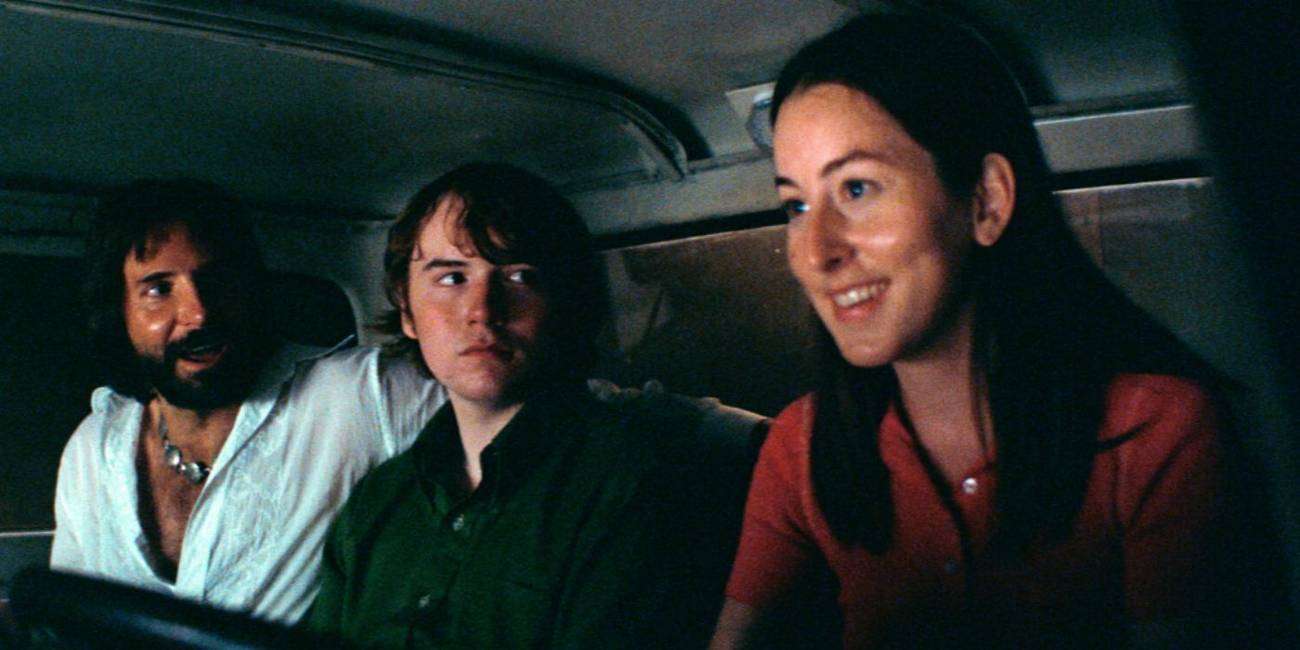 Bradley Cooper, Cooper Hoffman, and Alana Haim as Jon Peters, Gary, and Alana driving in a car at night in 'Licorice Pizza'