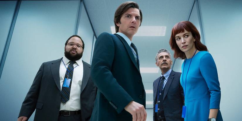 Zach Cherry, Adam Scott, John Turturro, and Britt Lower looking tense in a hallway in a promo for Severance.