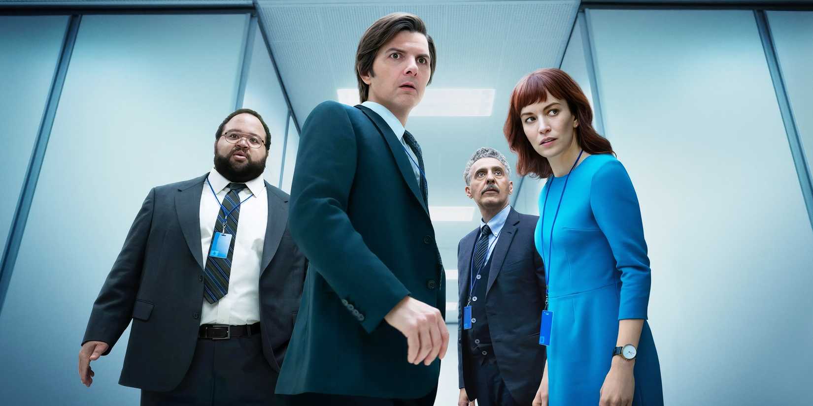 Four people in a hallway looking scared in Severance.