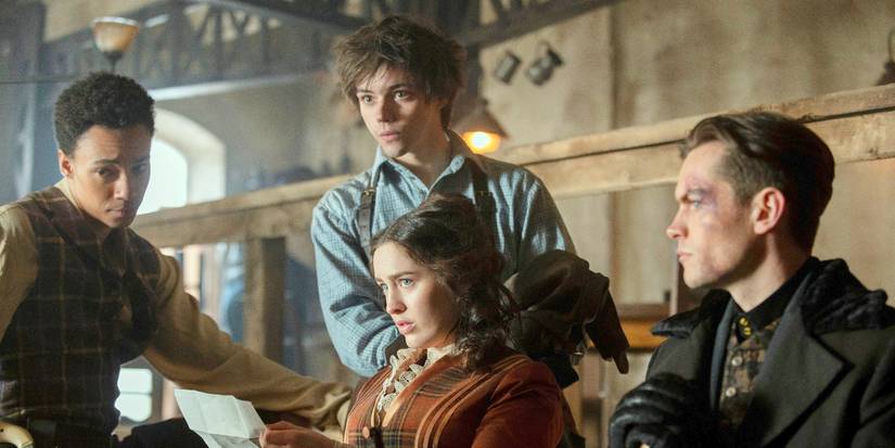 Jesper and Wylan standing next to a seated Nina and Kaz in Shadow and Bone Season 2