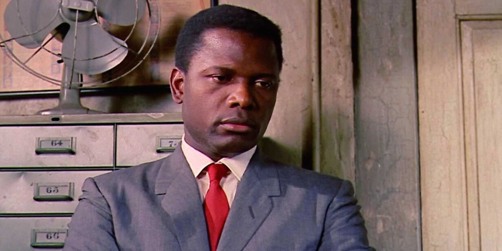 Sidney Poitier as Virgil Tibbs looking down with a serious expression in In the Heat of the Night, 1967.