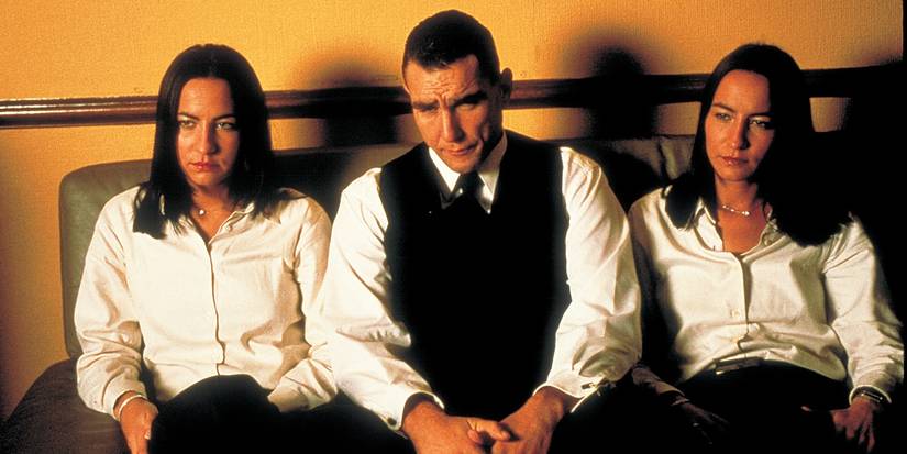 Vinnie Jones sitting between two women in Snatch