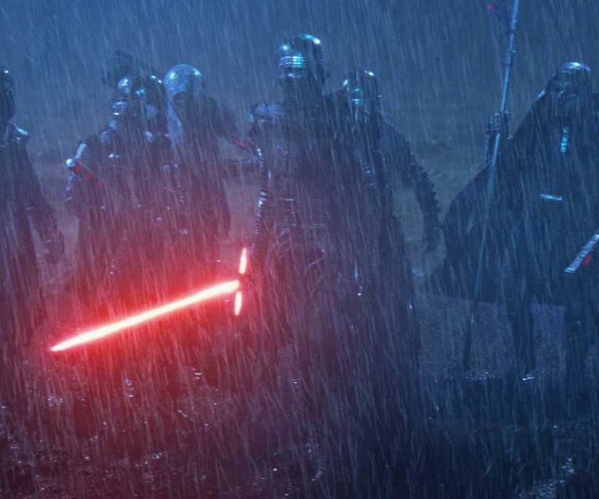 Kylo Ren stands in front of the Knights of Ren in a dark, rain-soaked landscape