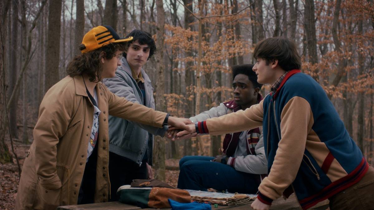 Gaten Matarazzo as Dustin, Finn Wolfhard as Mike, Caleb McLaughlin as Lucas, and Noah Schnapp as Will are hands in on 'Stranger Things' Season 5.
