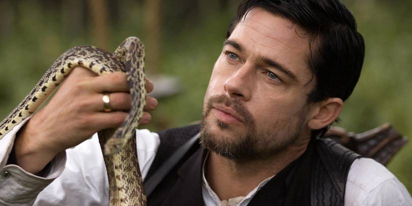 Brad Pitt looking at a snake in The Assassination of Jesse James by the Coward Robert Ford