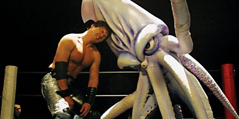A man fighting a giant squid inside a wrestling ring in The Calamari Wrestler (2004).