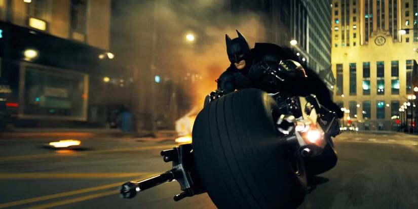 Batman racing through the streets on a motorcycle in The Dark Knight (2008).