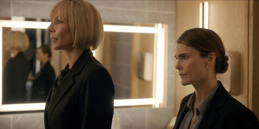 Allison Janney as Grace and Keri Russell as Kate looking ahead in a bathroom on The Diplomat Season 3.