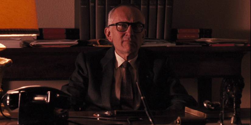 An old man behind a desk frowning in The Godfather Part III