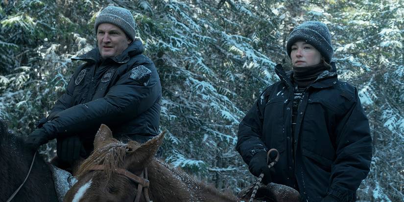 A man and a woman riding horses side by side in the winter in The Last Frontier.
