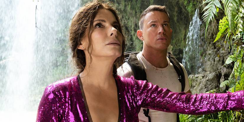 Sandra Bullock as Loretta and Channing Tatum as Alan looking up by a waterfall in The Lost City.