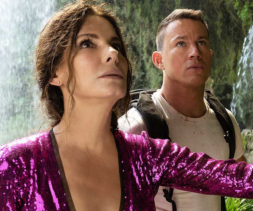 Sandra Bullock as Loretta and Channing Tatum as Alan looking up by a waterfall in The Lost City.