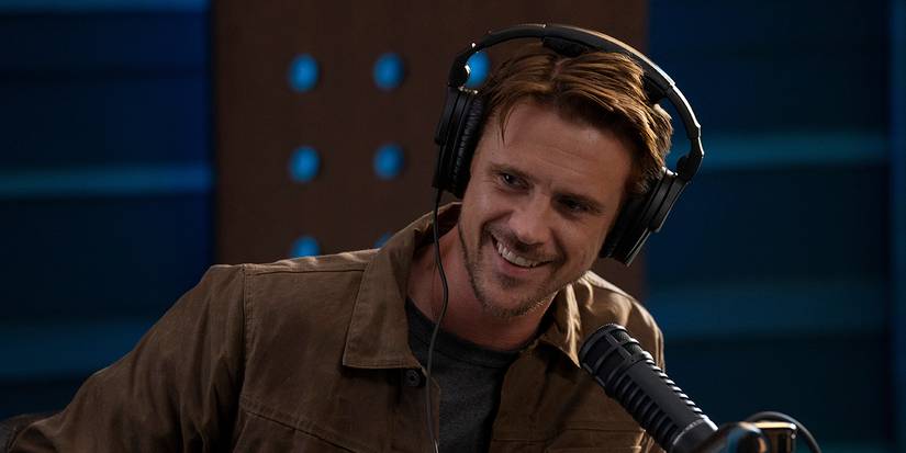Brody smiling wearing a headset with a mic in front of him on The Morning Show.