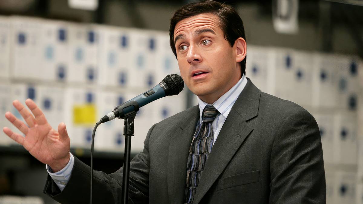 Steve Carell's Michael Scott talking at a podium in The Office. 