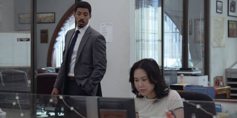 Detrick (Melvin Gregg) looks on as Nicole (Ramona Young) works on her computer in The Paper