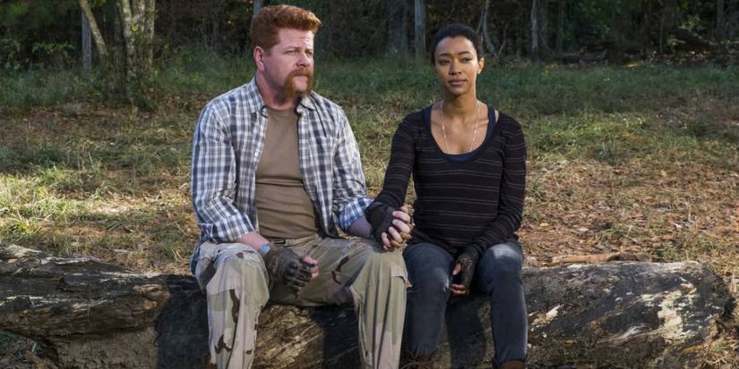 Michael Cudlitz as Abraham and Sonique Martin-Green as Sasha holding hands on The Walking Dead.