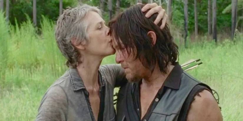 Melissa McBride as Carol kisses the forehead of Norman Reedus as Daryl Dixon on The Walking Dead.