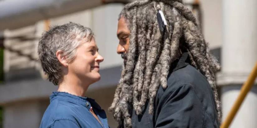 Melissa McBride as Carol Peletier and Khary Payton as Ezekial Sutton look at each other on The Walking Dead.