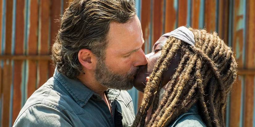 Andrew Lincoln as Rick Grimes and Danai Gurira as Michonne kissing on The Walking Dead.