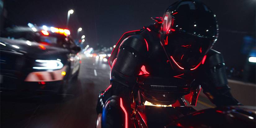 Close-up of Ares on a Light Cycle being chased by a cop car in Tron: Ares.