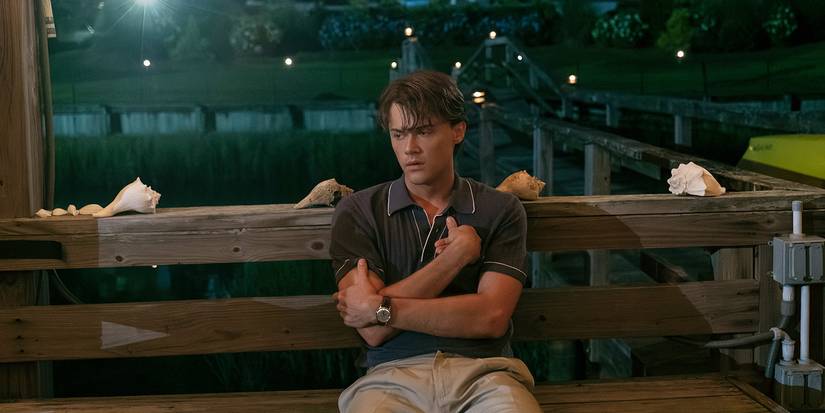 Christopher Briney as Conrad holding himself and struggling in The Summer I Turned Pretty