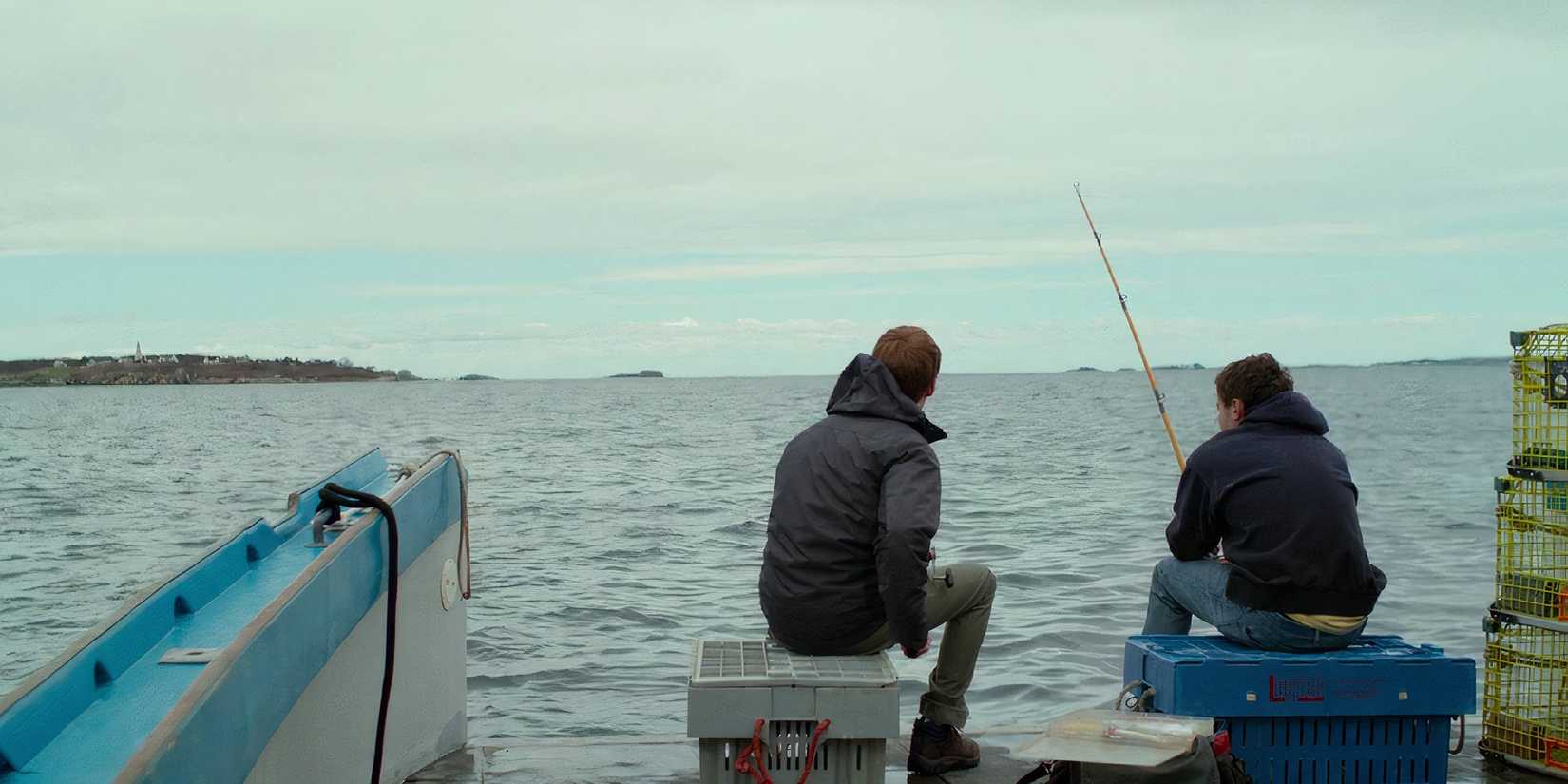 Two men sit side by side in Manchester By the Sea