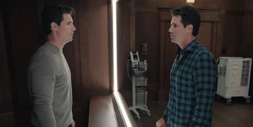 The two Nathans looking at one another through glass in Upload.